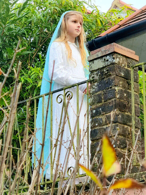 A young child playing Mary in a College production